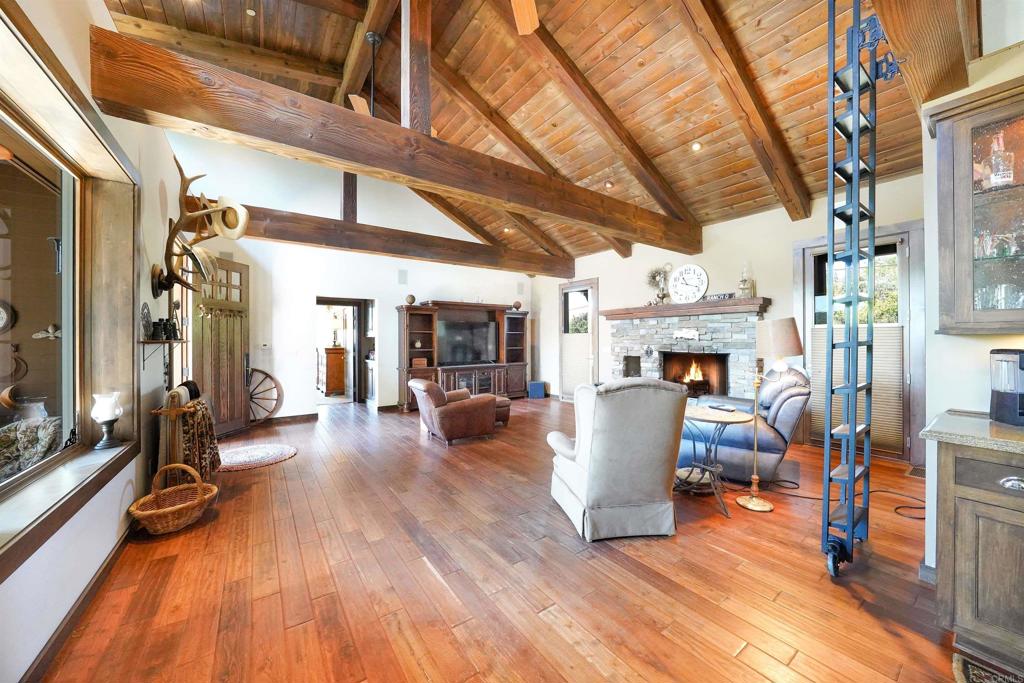 21057 Sutherland Dam Road Ramona, CA 92065 - Photo 23 of 66 a view of a living room with furniture and a fireplace