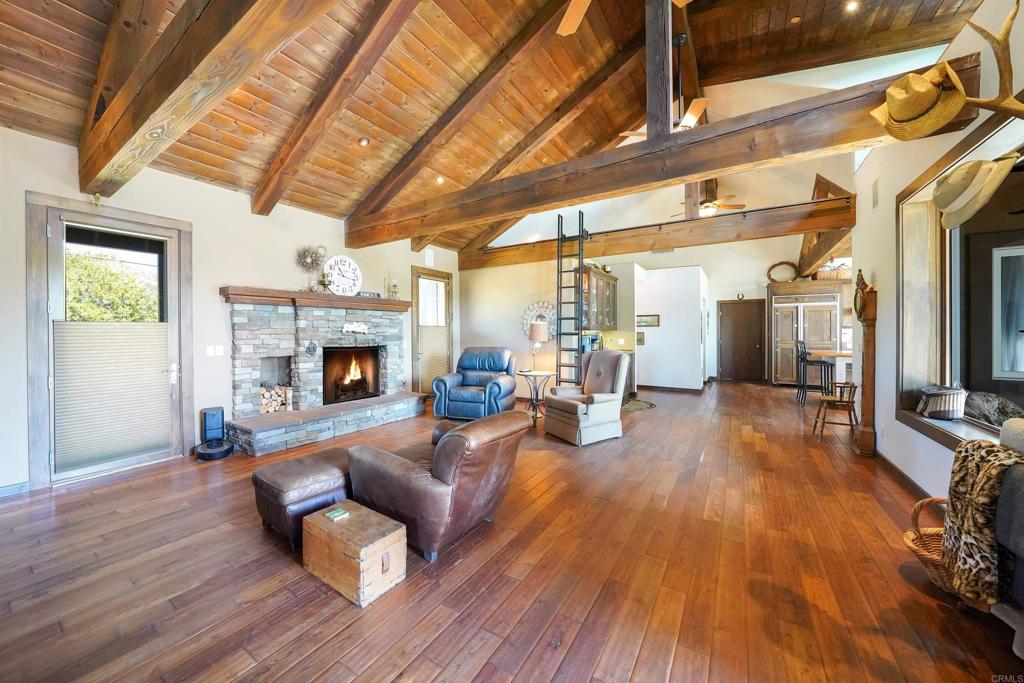 21057 Sutherland Dam Road Ramona, CA 92065 - Photo 24 of 66 a living room with furniture and a fireplace