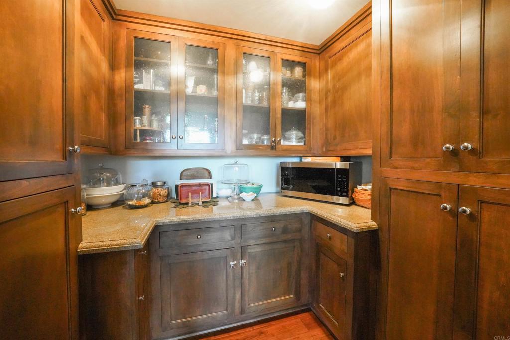 21057 Sutherland Dam Road Ramona, CA 92065 - Photo 30 of 66 a kitchen with stainless steel appliances granite countertop a sink and cabinets