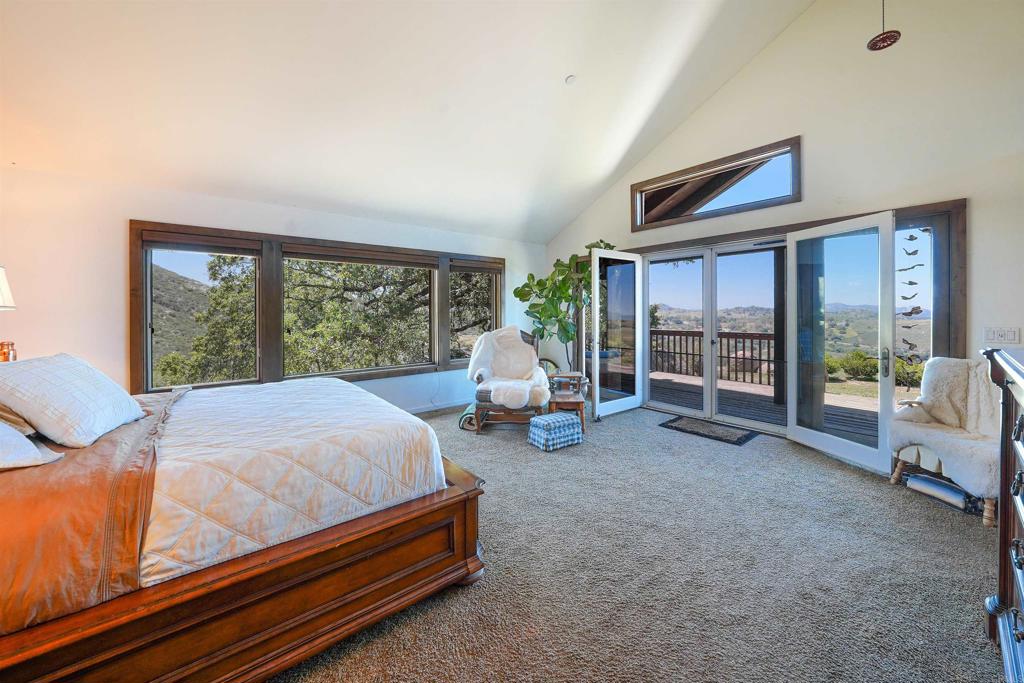 21057 Sutherland Dam Road Ramona, CA 92065 - Photo 36 of 66 a bed room with a bed and a chair