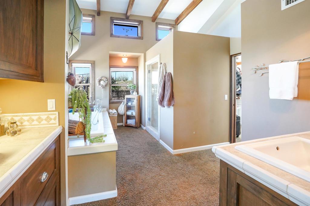 21057 Sutherland Dam Road Ramona, CA 92065 - Photo 38 of 66 a bathroom with a tub sink and mirror