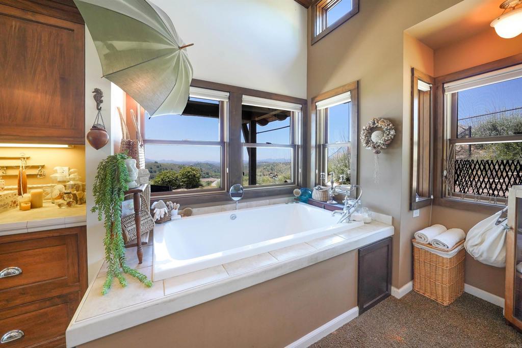 21057 Sutherland Dam Road Ramona, CA 92065 - Photo 39 of 66 a spacious bathroom with a bathtub and next to a window
