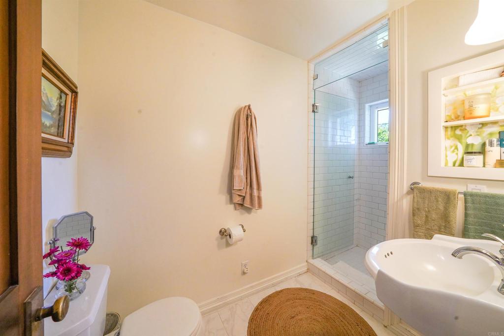 21057 Sutherland Dam Road Ramona, CA 92065 - Photo 41 of 66 a bathroom with a granite countertop bathtub sink vanity mirror and toilet