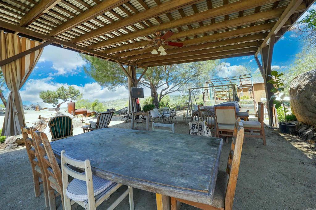 21057 Sutherland Dam Road Ramona, CA 92065 - Photo 57 of 66 a view of a patio with table and chairs and potted plants