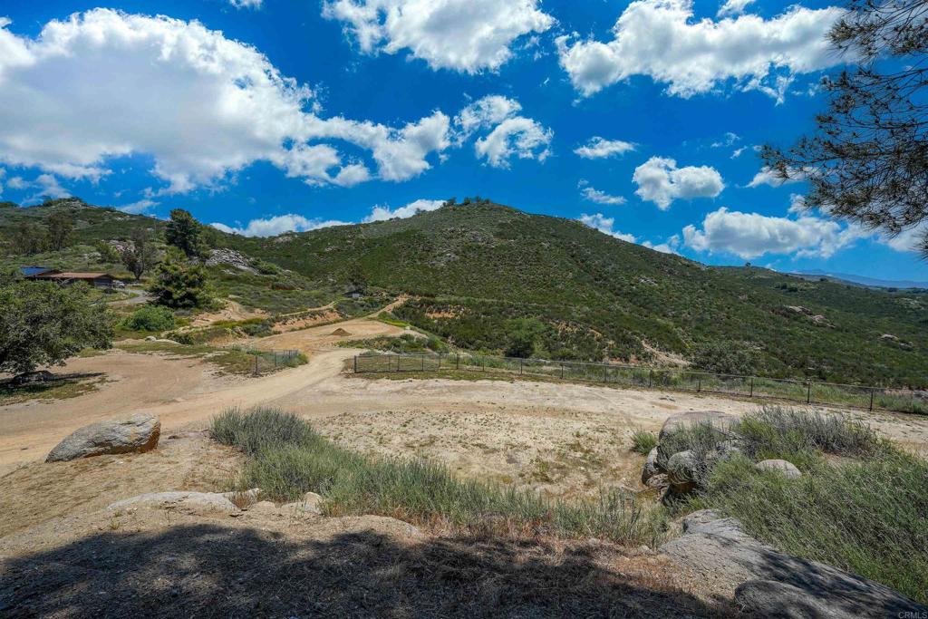 21057 Sutherland Dam Road Ramona, CA 92065 - Photo 66 of 66 a view of a backyard of a house with a mountain