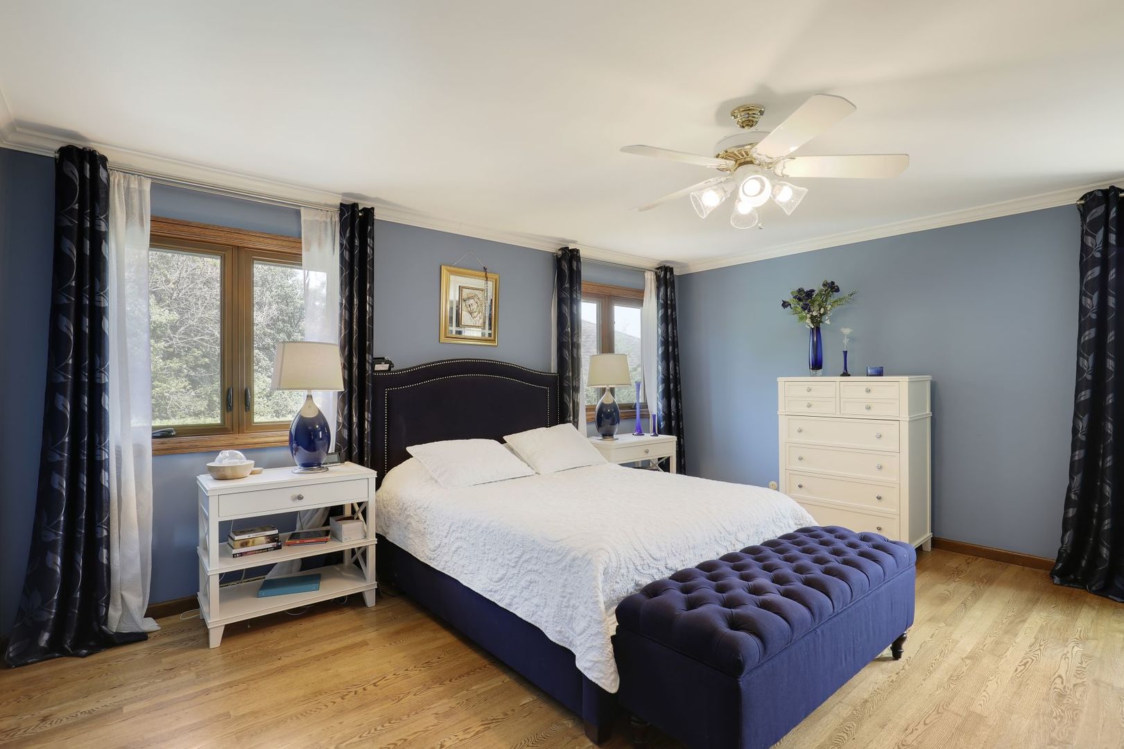 11400 Burr Oak Lane Burr Ridge, IL 60527 - Photo 19 of 40 a bedroom with a bed and a chandelier