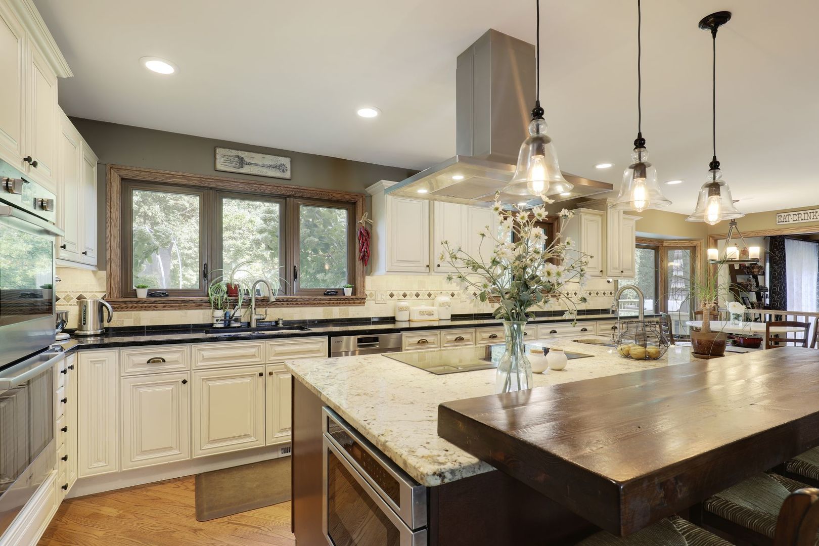 11400 Burr Oak Lane Burr Ridge, IL 60527 - Photo 4 of 40 a kitchen with kitchen island granite countertop a sink a counter top space appliances and cabinets