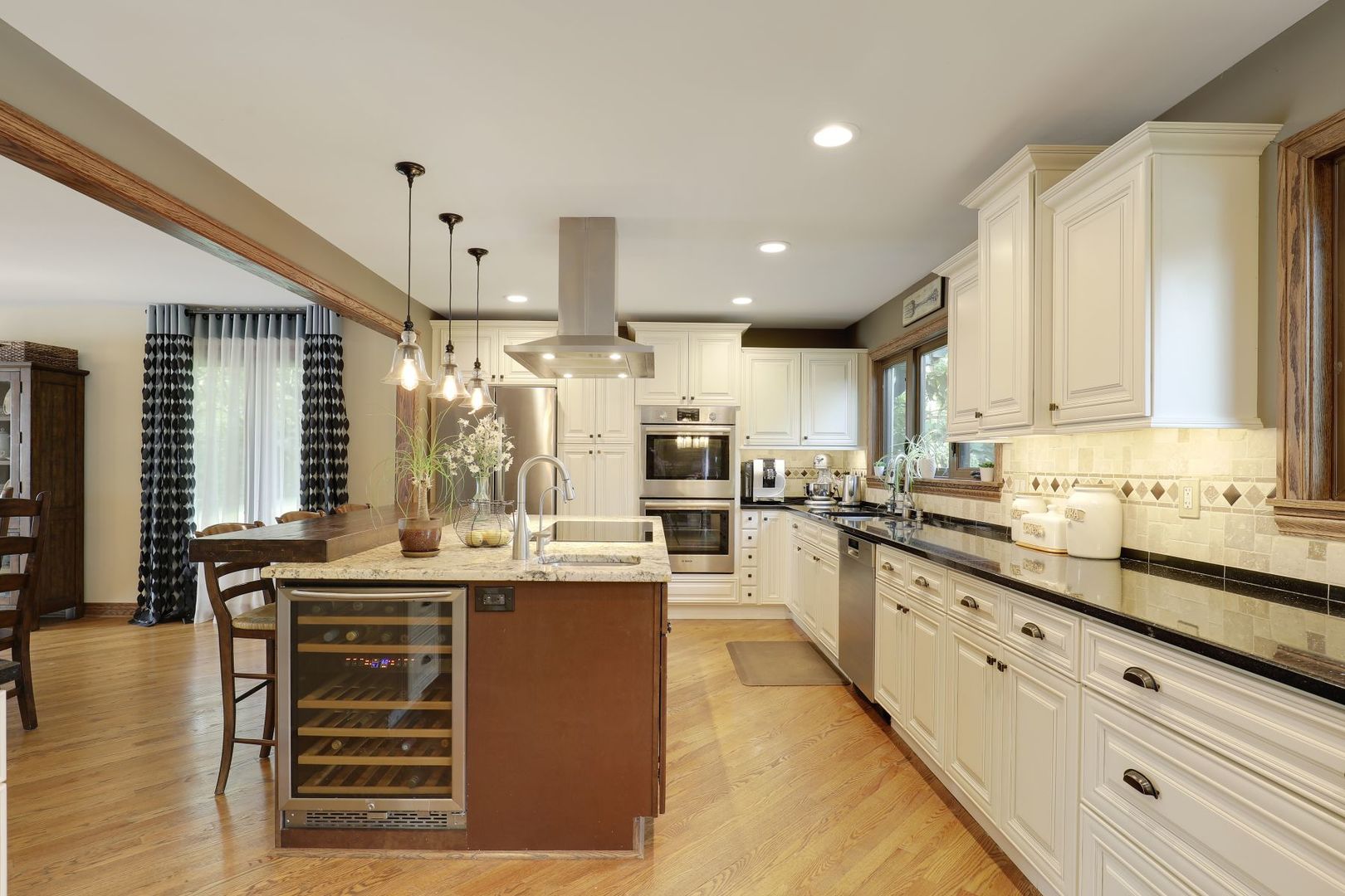 11400 Burr Oak Lane Burr Ridge, IL 60527 - Photo 5 of 40 a kitchen with kitchen island granite countertop a sink cabinets and wooden floor