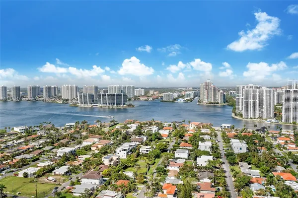 a bedroom with a bed and a lamp next to a window
