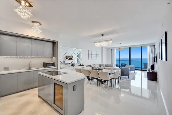 a view of kitchen with cabinets table and chairs