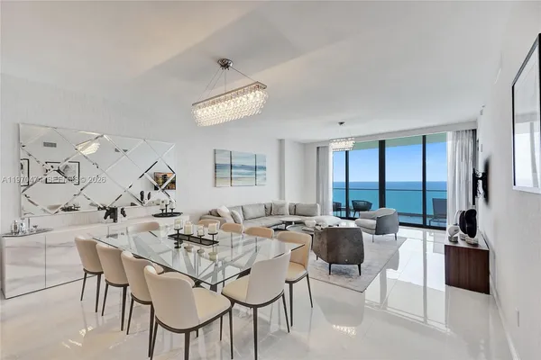a view of a dining room with furniture and a large window