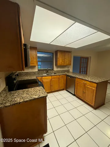a kitchen with stainless steel appliances granite countertop a sink and a stove top oven