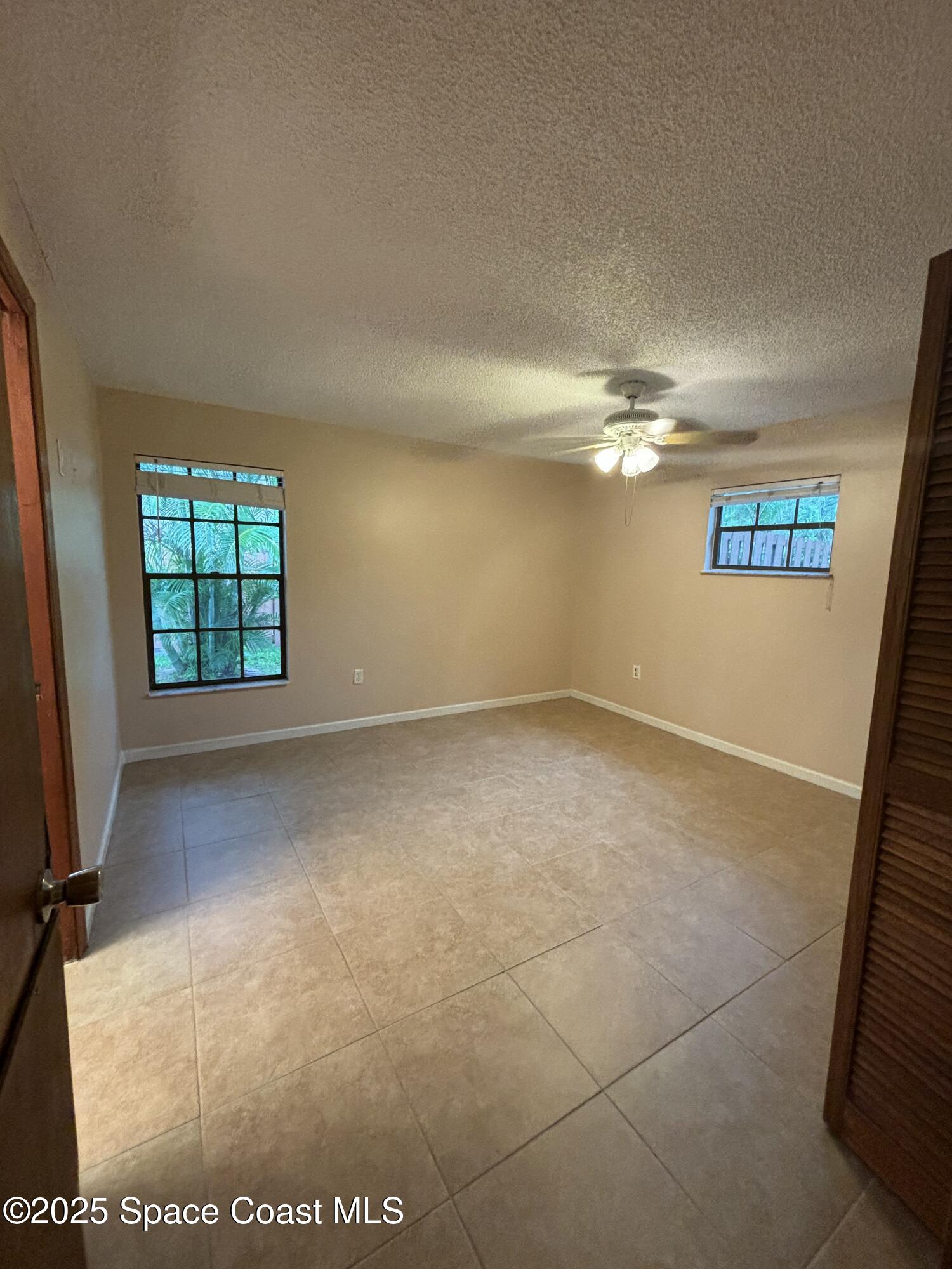 1201 Northeast Tropicana Road Palm Bay, FL 32905 - Photo 11 of 23 an empty room with windows