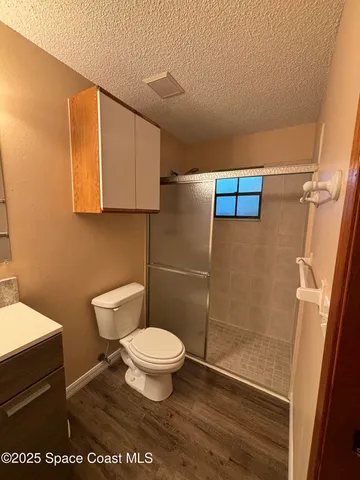 a bathroom with a toilet and a shower