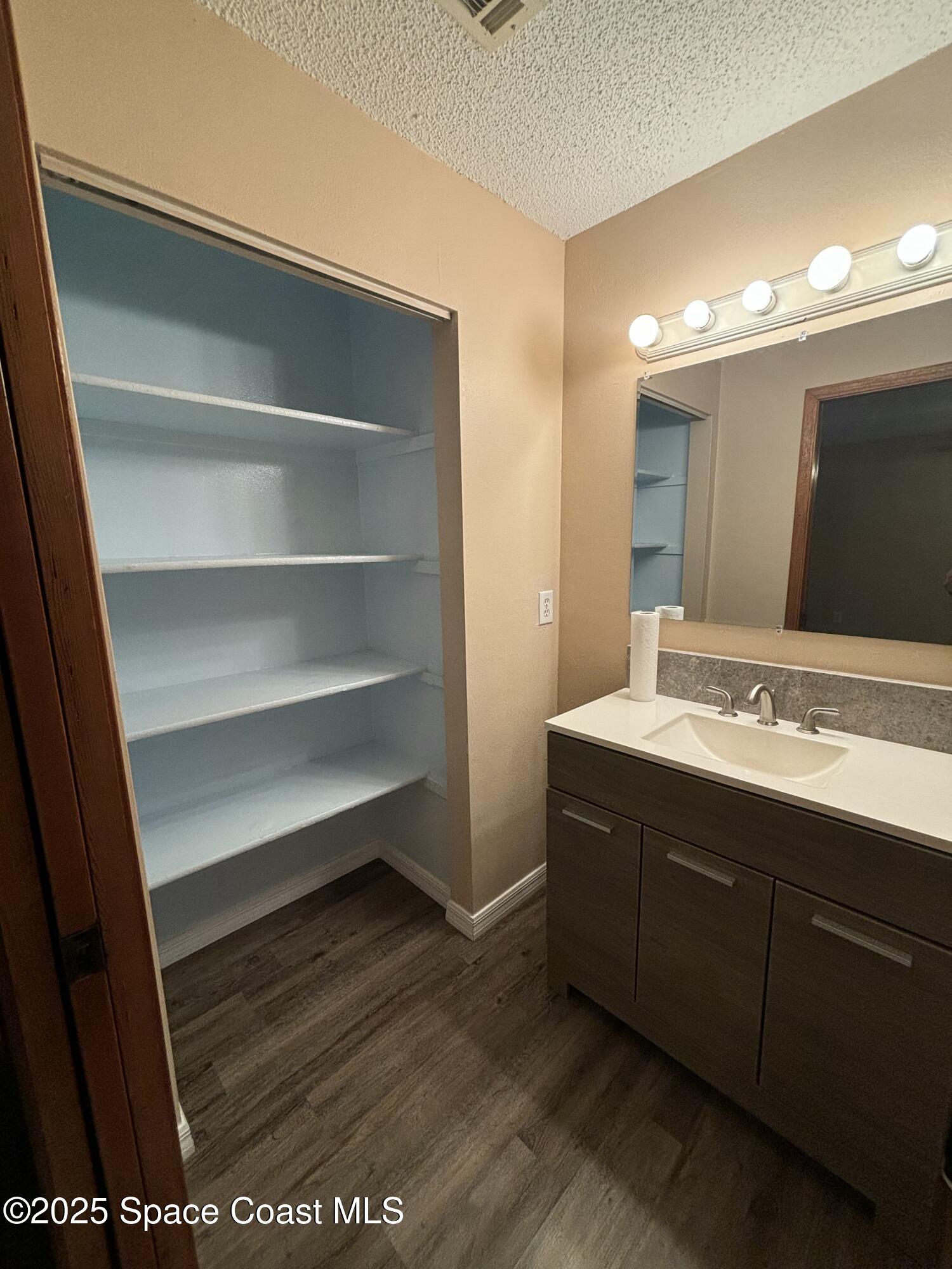 1201 Northeast Tropicana Road Palm Bay, FL 32905 - Photo 14 of 23 a bathroom with a sink and a mirror