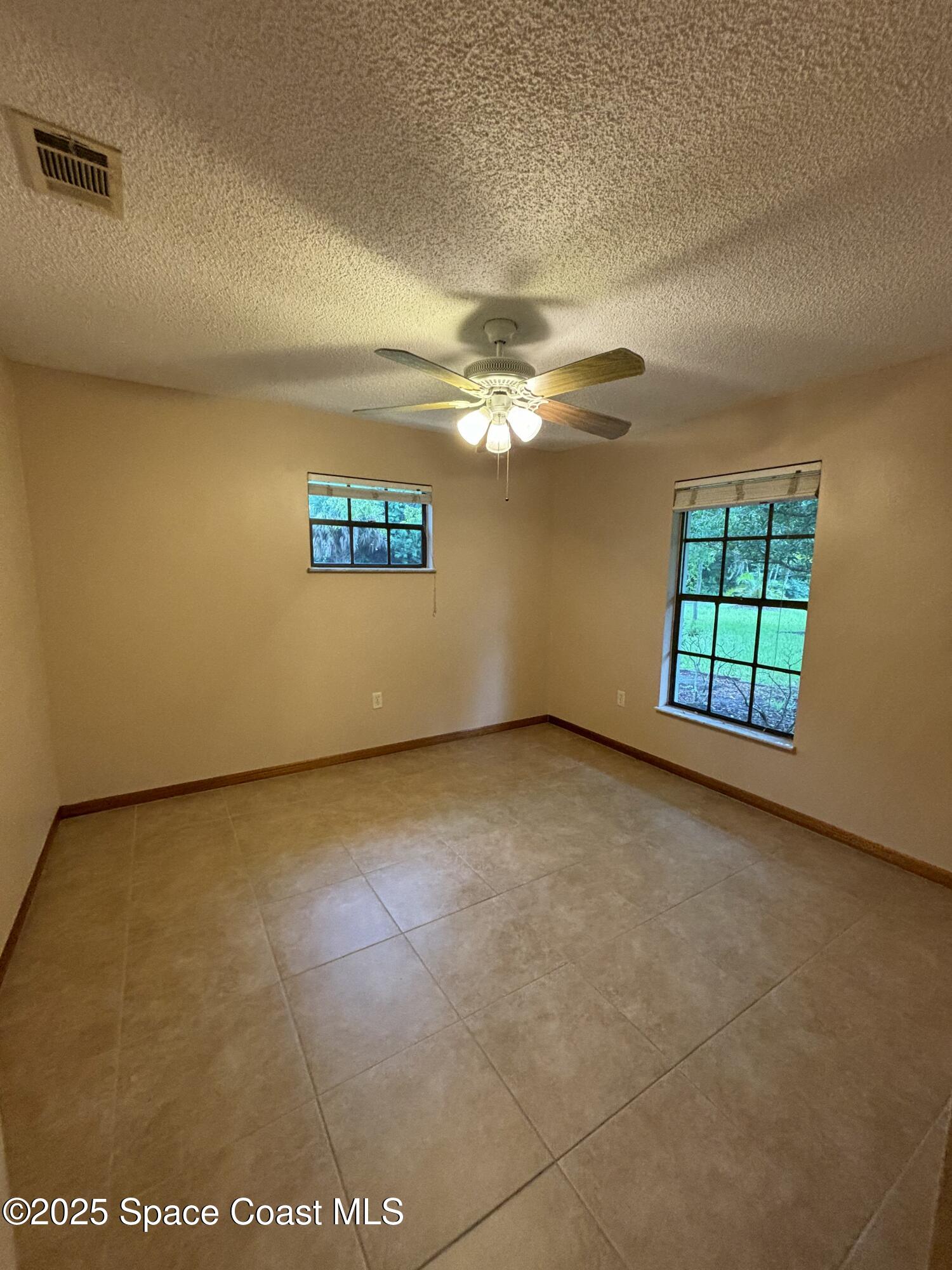1201 Northeast Tropicana Road Palm Bay, FL 32905 - Photo 16 of 23 a view of an empty room with a window