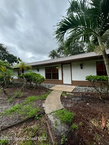a front view of house with yard space and garden