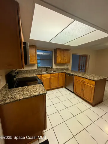 a kitchen with stainless steel appliances granite countertop a sink and a stove