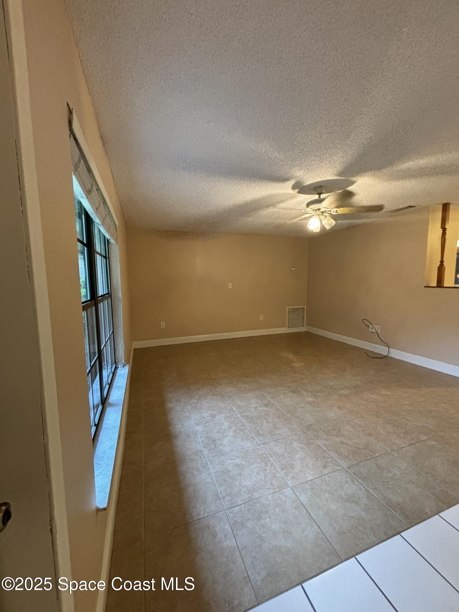 1201 Northeast Tropicana Road Palm Bay, FL 32905 - Photo 7 of 23 wooden floor in an empty room