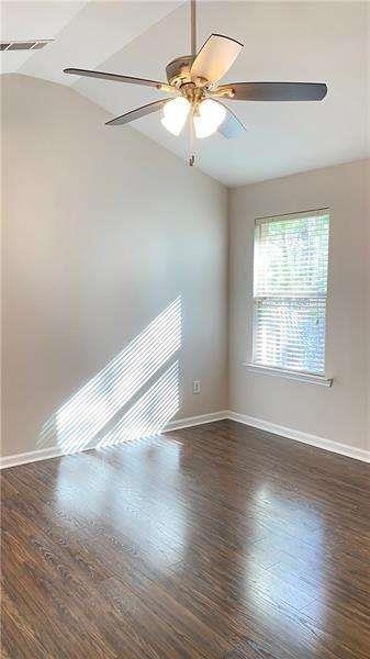 4408 Black Hills Drive Northwest Kennesaw, GA 30144 - Photo 13 of 33 an empty room with wooden floor chandelier fan and windows