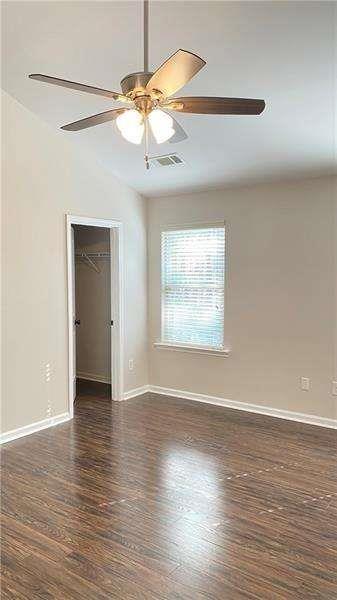 4408 Black Hills Drive Northwest Kennesaw, GA 30144 - Photo 19 of 33 an empty room with wooden floor chandelier fan and windows