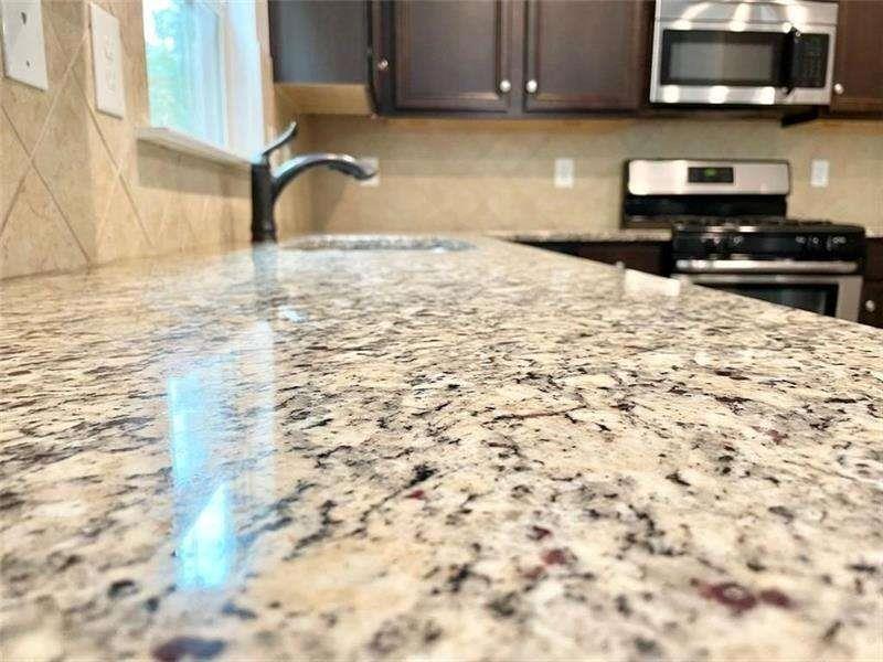 4408 Black Hills Drive Northwest Kennesaw, GA 30144 - Photo 3 of 33 a bathroom with a sink and a stove top oven