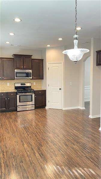 4408 Black Hills Drive Northwest Kennesaw, GA 30144 - Photo 10 of 33 a kitchen with kitchen island stainless steel appliances a stove and a sink