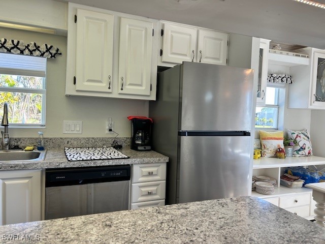 19681 Summerlin Road, Unit 404 Fort Myers, FL 33908 - Photo 7 of 34 a kitchen with stainless steel appliances granite countertop a refrigerator sink and stove