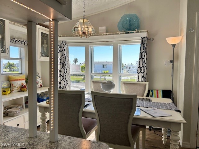 19681 Summerlin Road, Unit 404 Fort Myers, FL 33908 - Photo 9 of 34 a view of a dining room with furniture and chandelier