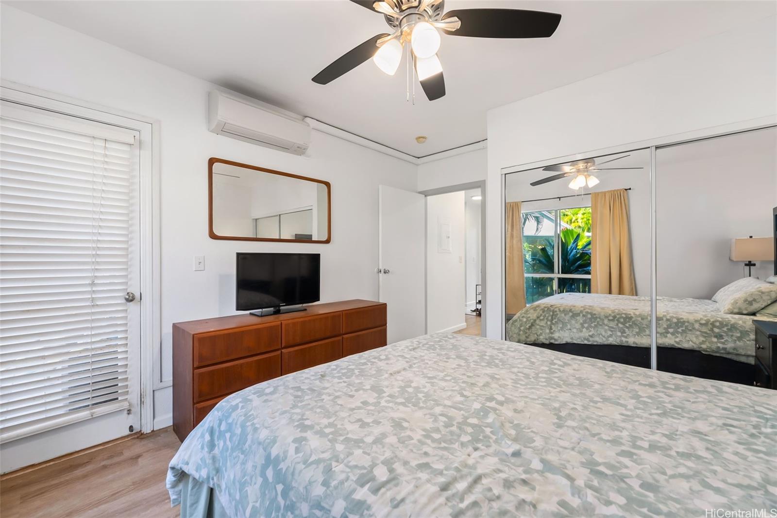 95-919 Wikao Street, Unit F103 Mililani, HI 96789 - Photo 12 of 25 a bedroom with a bed and a fireplace