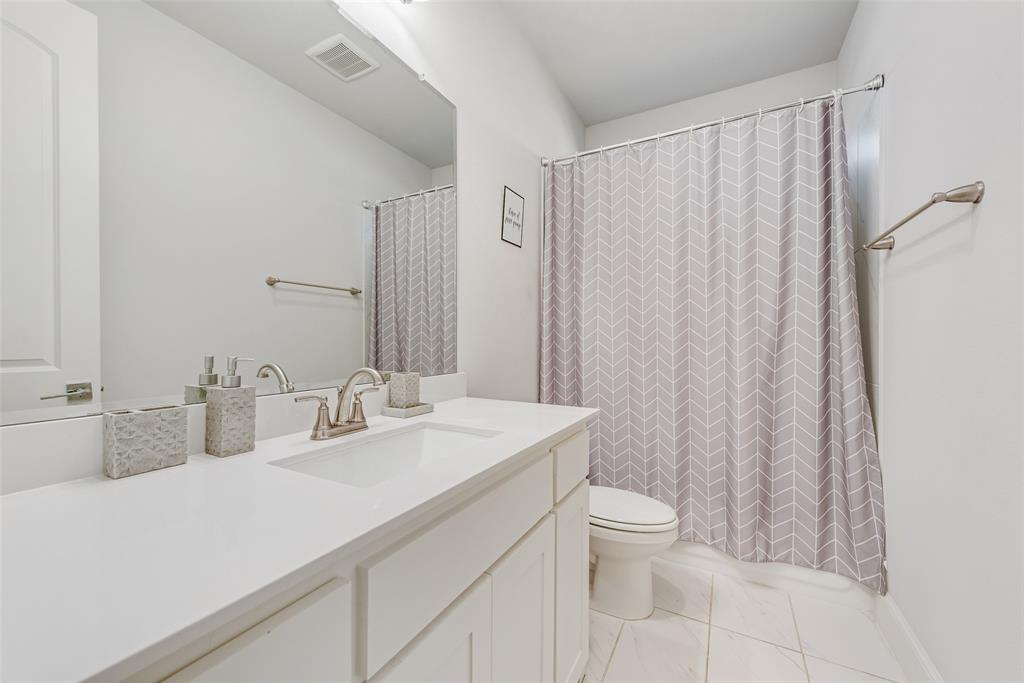 2341 Haft River Road Frisco, TX 75034 - Photo 28 of 36 Full bathroom with vanity, curtained shower, and light tile patterned floors