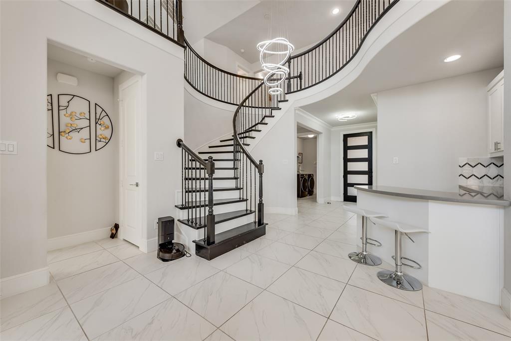 2341 Haft River Road Frisco, TX 75034 - Photo 3 of 36 Stairway featuring a towering ceiling, a chandelier, recessed lighting, and marble finish floors
