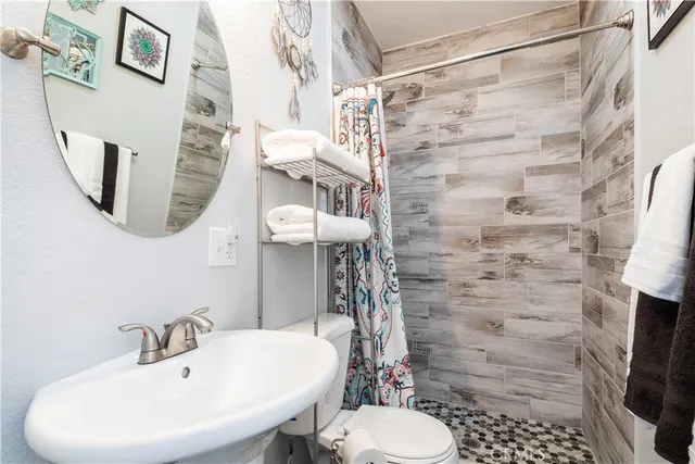 a bedroom with two beds and wooden floor