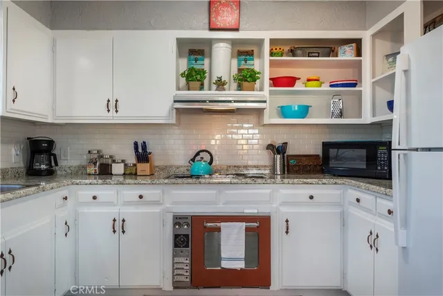 a bedroom with two beds and a fireplace