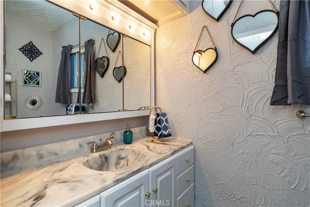 a kitchen with wooden floors and a sink