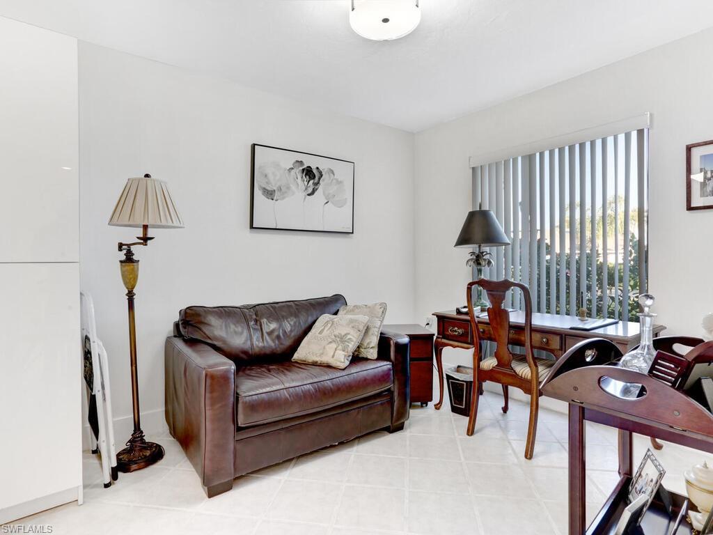 1232 Commonwealth Circle, Unit P102 Naples, FL 34116 - Photo 17 of 30 a living room with furniture and a window