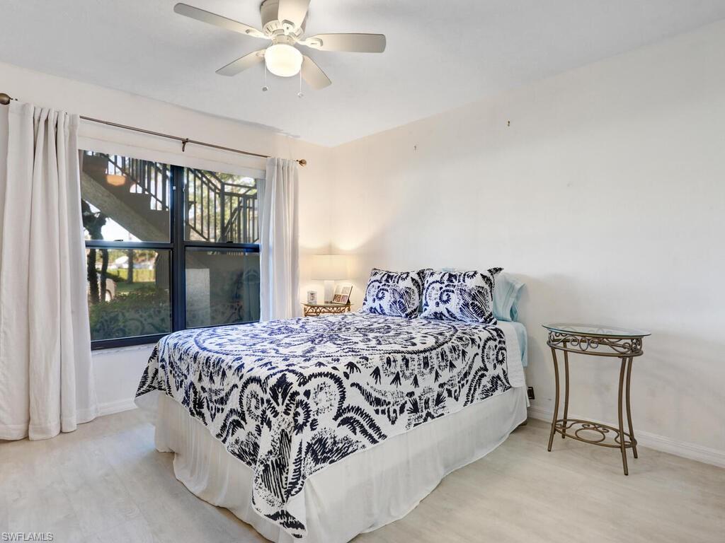 1232 Commonwealth Circle, Unit P102 Naples, FL 34116 - Photo 22 of 30 a bedroom with a bed and a window