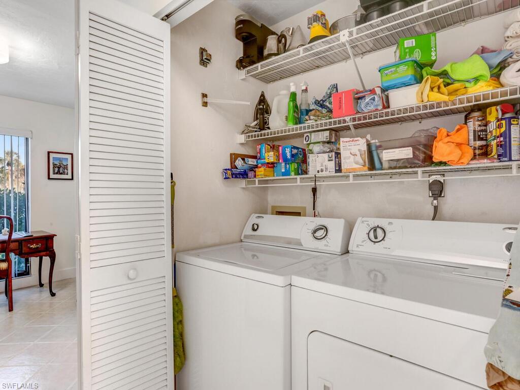 1232 Commonwealth Circle, Unit P102 Naples, FL 34116 - Photo 26 of 30 a utility room with dryer and washer