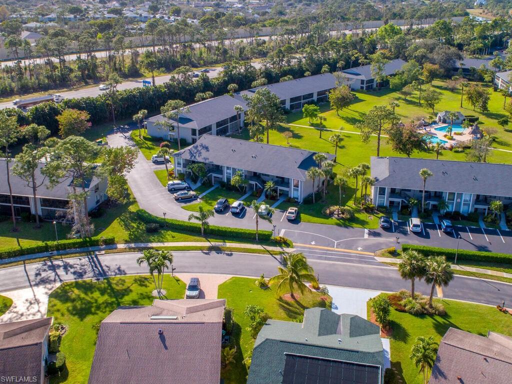 1232 Commonwealth Circle, Unit P102 Naples, FL 34116 - Photo 28 of 30 an aerial view of a houses with an outdoor space and seating area