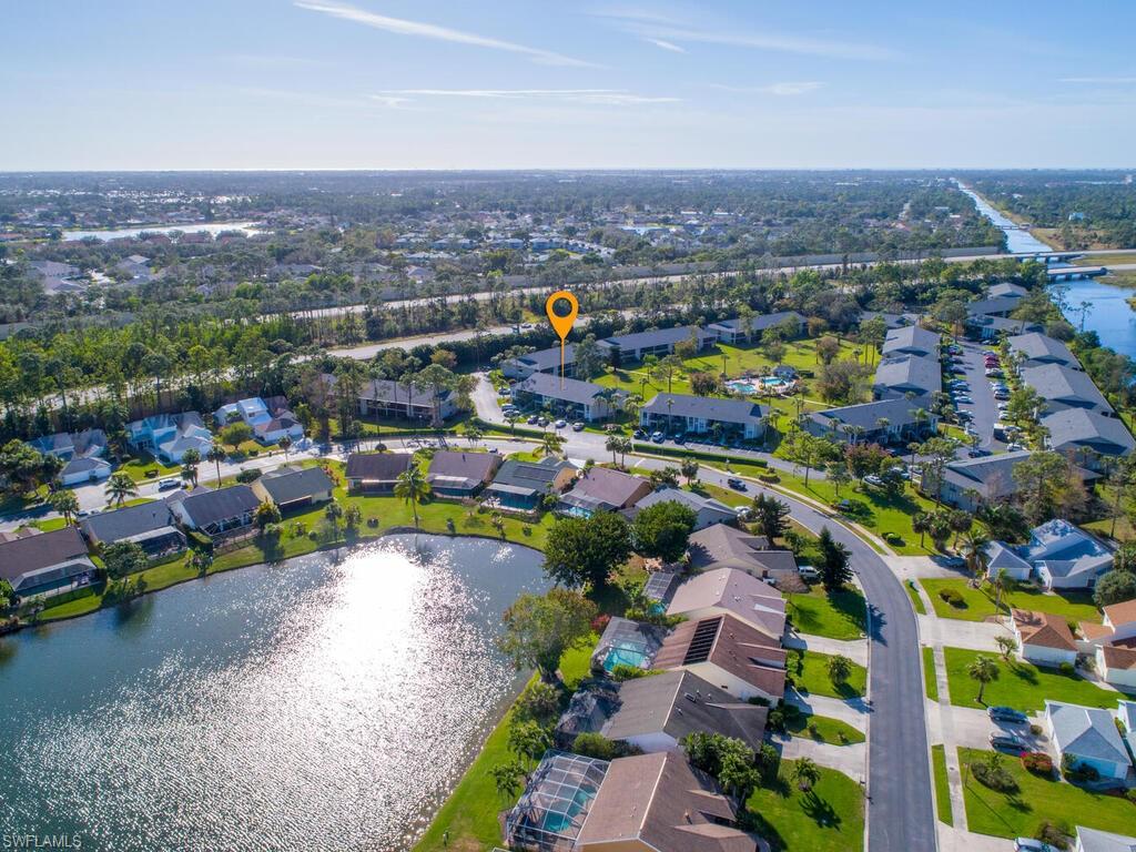 1232 Commonwealth Circle, Unit P102 Naples, FL 34116 - Photo 29 of 30 an aerial view of a house with a swimming pool yard and outdoor seating