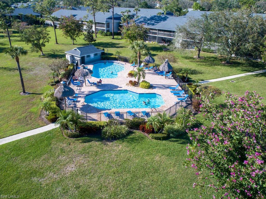 1232 Commonwealth Circle, Unit P102 Naples, FL 34116 - Photo 3 of 30 an aerial view of a house with a garden and swimming pool