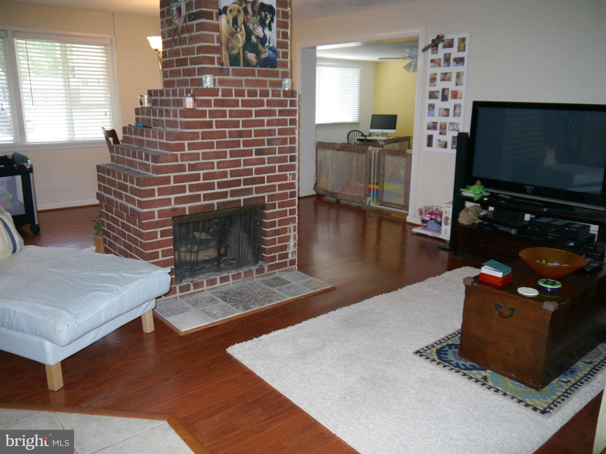 7412 Inzer Street Springfield, VA 22151 - Photo 2 of 27 a living room with furniture and a flat screen tv