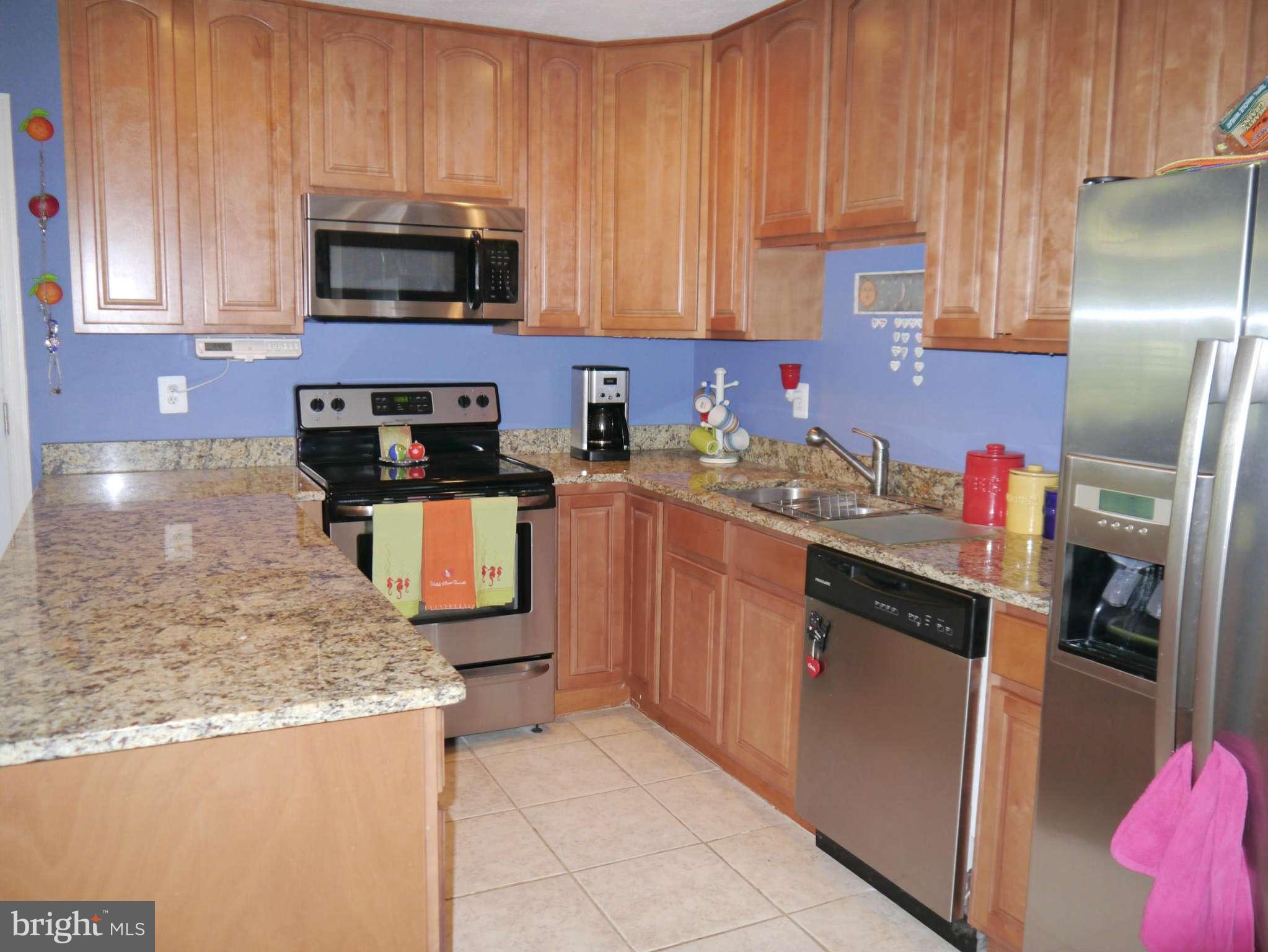 7412 Inzer Street Springfield, VA 22151 - Photo 11 of 27 a kitchen with stainless steel appliances granite countertop a refrigerator stove top oven a sink and dishwasher