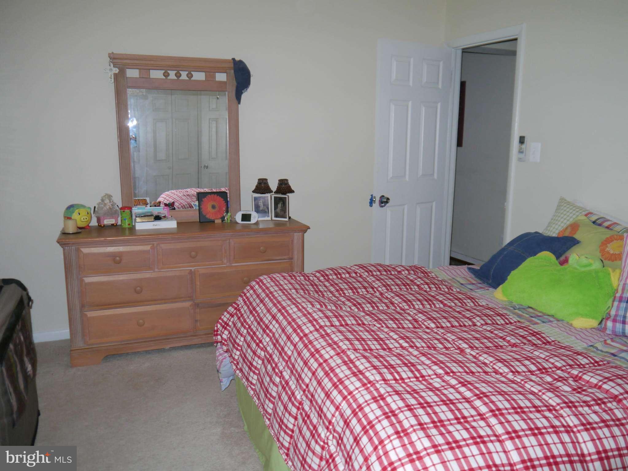 7412 Inzer Street Springfield, VA 22151 - Photo 18 of 27 a bedroom with a bed and a dresser