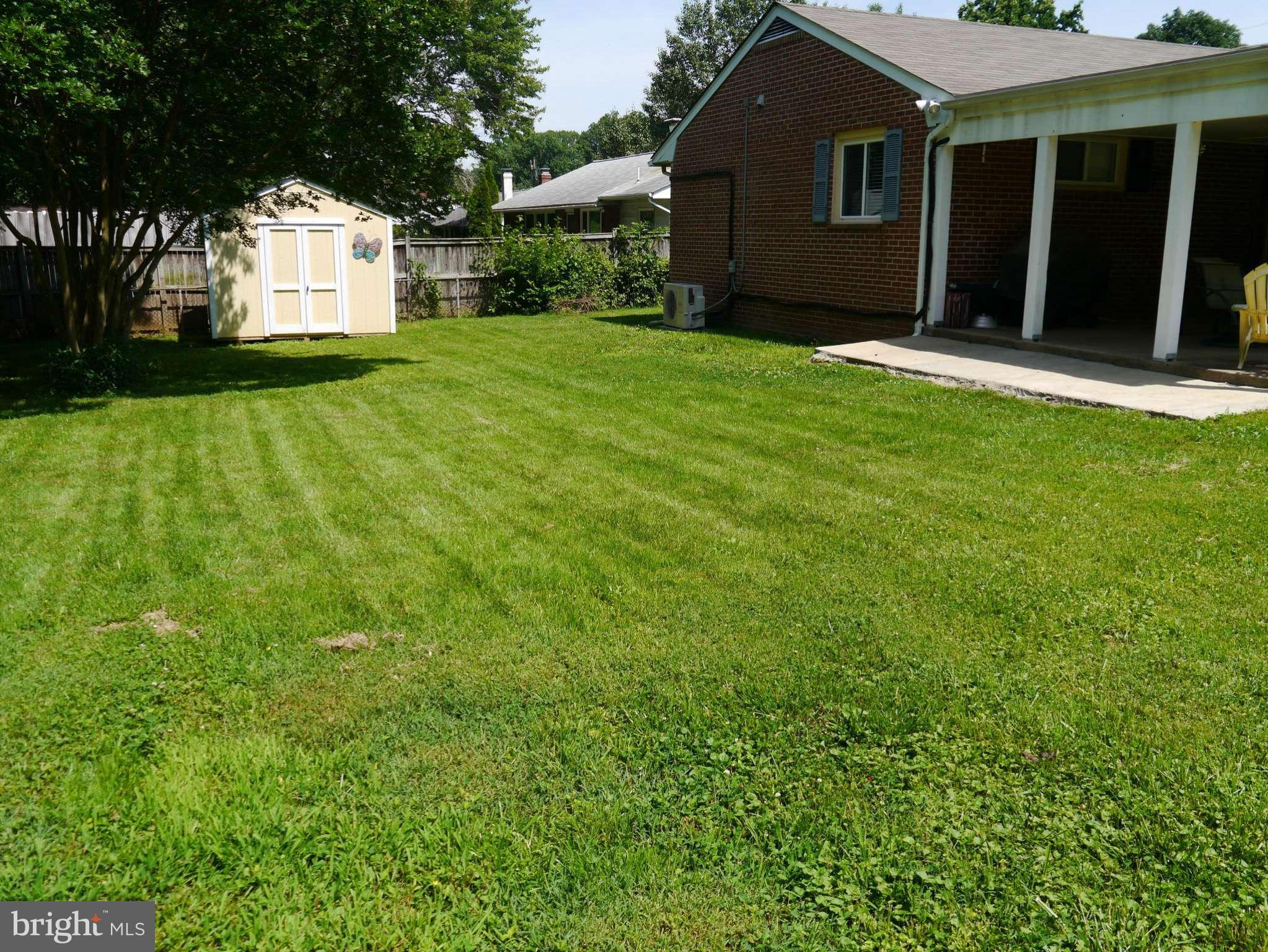 7412 Inzer Street Springfield, VA 22151 - Photo 20 of 27 a front view of a house with a yard and garage