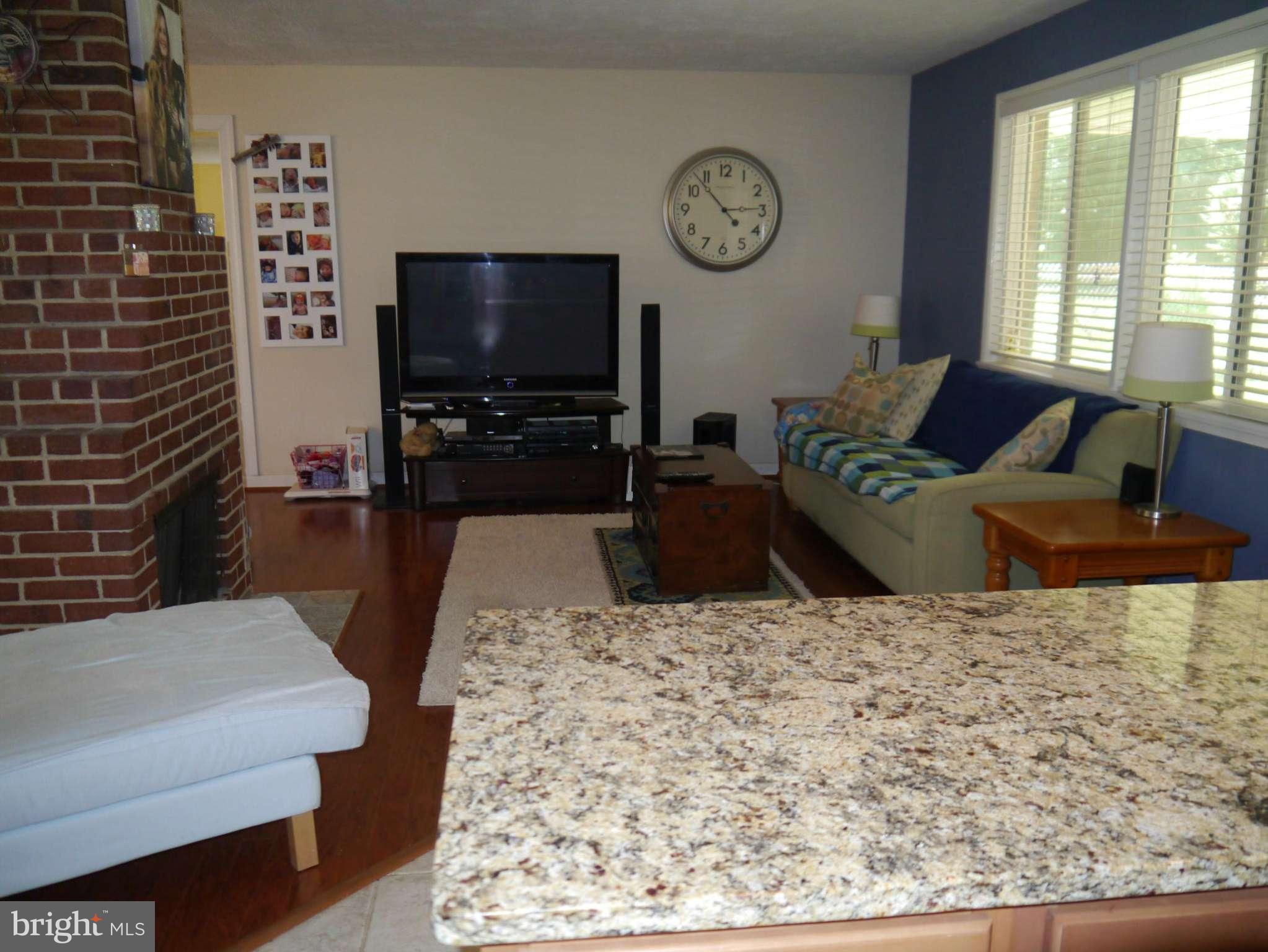 7412 Inzer Street Springfield, VA 22151 - Photo 3 of 27 a living room with furniture a flat screen tv and a large window