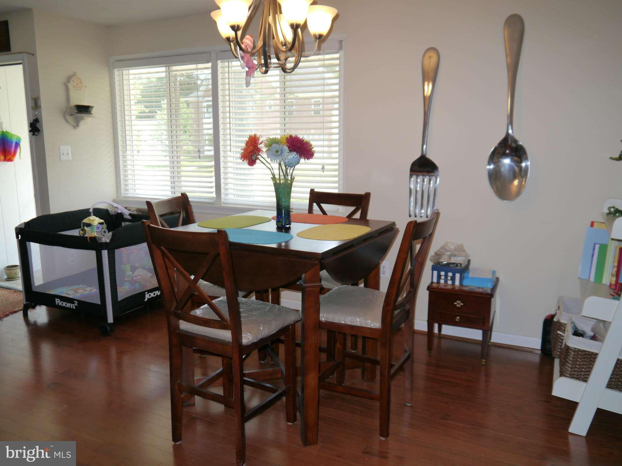 7412 Inzer Street Springfield, VA 22151 - Photo 4 of 27 a view of a dining room with furniture window and wooden floor