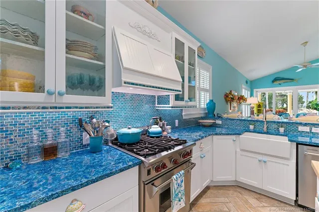 a living room with furniture a flat screen tv and a floor to ceiling window