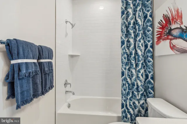 a bathroom with a bathtub and shower