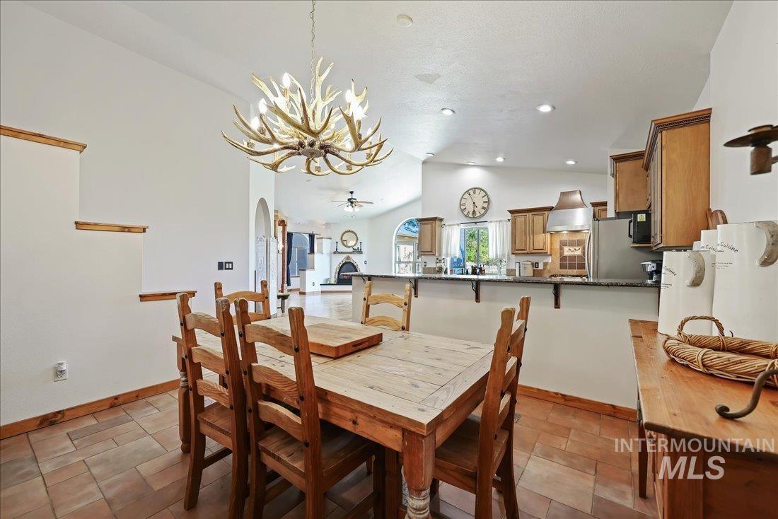 7639 Elko Lane Middleton, ID 83644 - Photo 16 of 47 Dining room featuring a ceiling fan, arched walkways, recessed lighting, a chandelier, and high vaulted ceiling